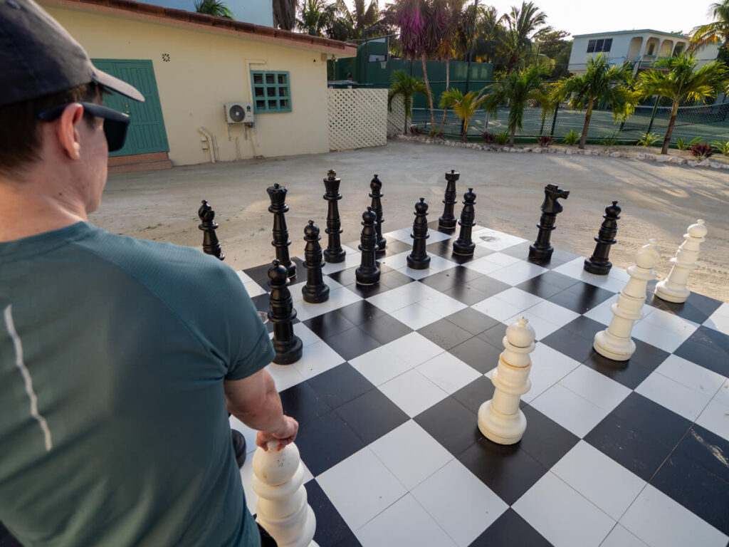 Dan picking up a giant chess piece ready to make his move.