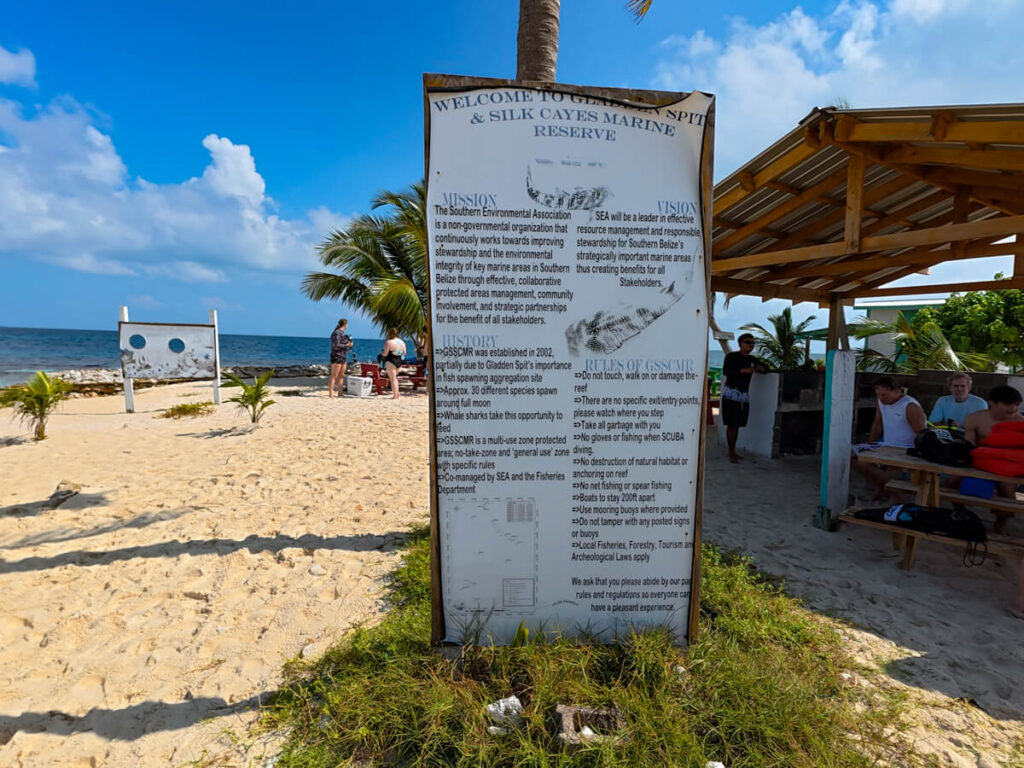 A large sign dictating the mission, vision, history, and rules of the Gladden Spit and Silk Cayes Marine Reserve.