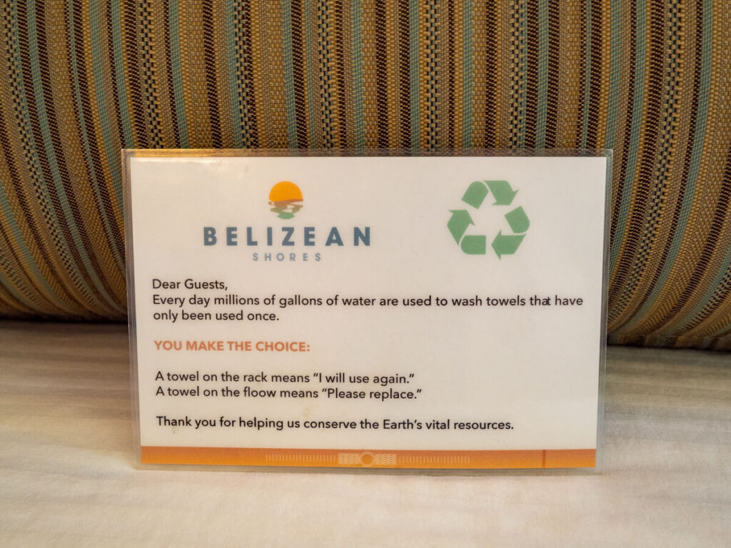 A notice by Belizean Shores reminding guests to conserve water by re-using towels.