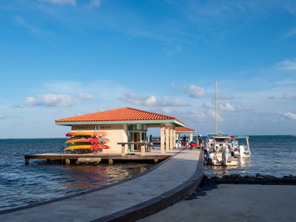 The private pier attached to Belizean Shores Resort. There are a couple of boats moored at the pier as well as a stack of kayaks that guests can hire for free.