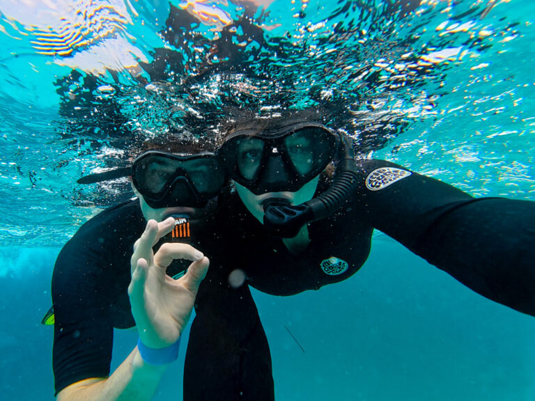 Dan and Lucy snorkelling together in the blue of the Hol Chan Marine Reserve.