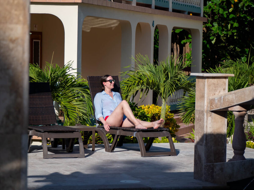 Lucy laughing as she looks out across the pool area at Belizean Shores Resort.