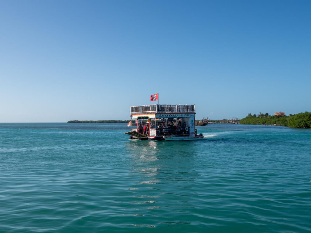 A small ferry called the "Rasta Ferry" crossing the Split in Caye Caulker. The Split is one of the best things to see in Caye Caulker.
