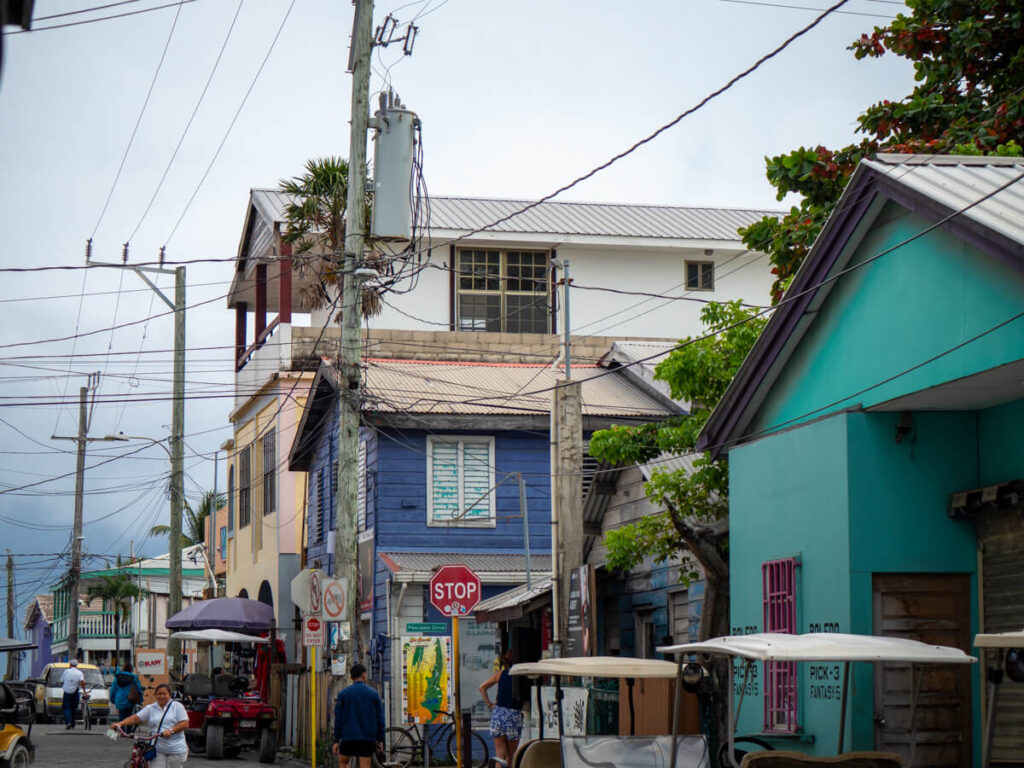 Colourful buildings on a street in San Pedro, Ambergris Caye. Some are made form wood, some from brick and some from concrete, adding a layer of variety and character to the scene.