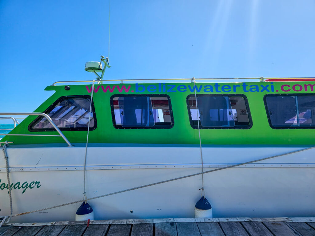 The side of a Belize Water Taxi, docked and awaiting passengers to embark.