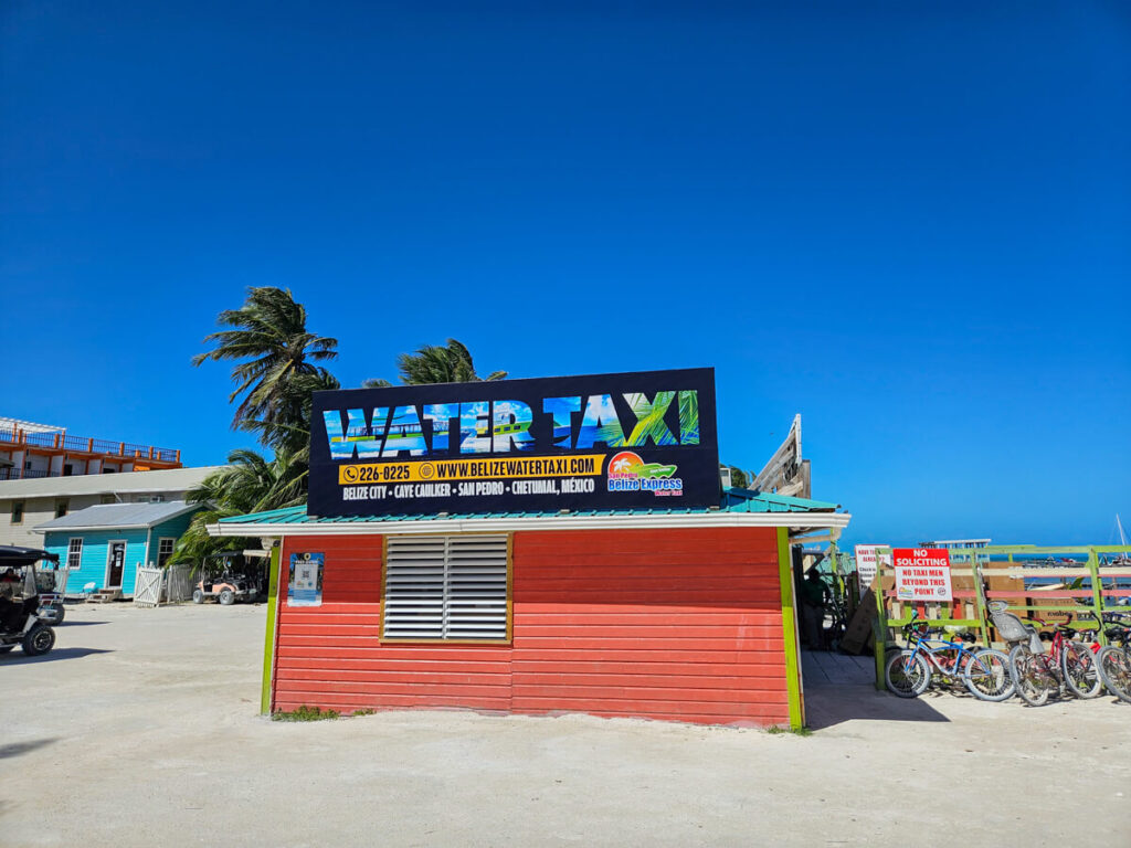A hut advertising water taxis for Belize City, Caye Caulker San Pedro, and Chetumal.