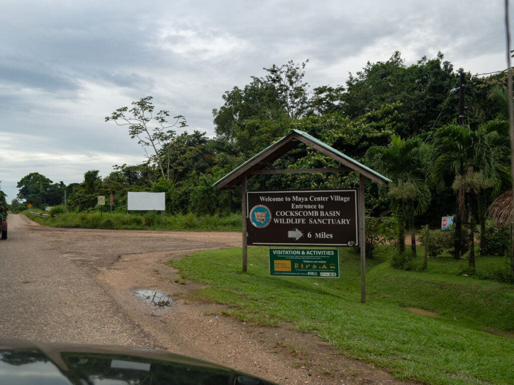 A sign pointing to the road to Cockscomb Basin Wildlife Sanctuary in Maya Center Village, Belize.