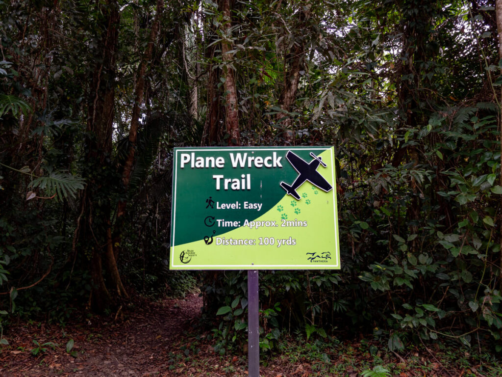 A sign marking the start of the Plane Wreck Trail at Cockscomb Basin Wildlife Sanctuary.