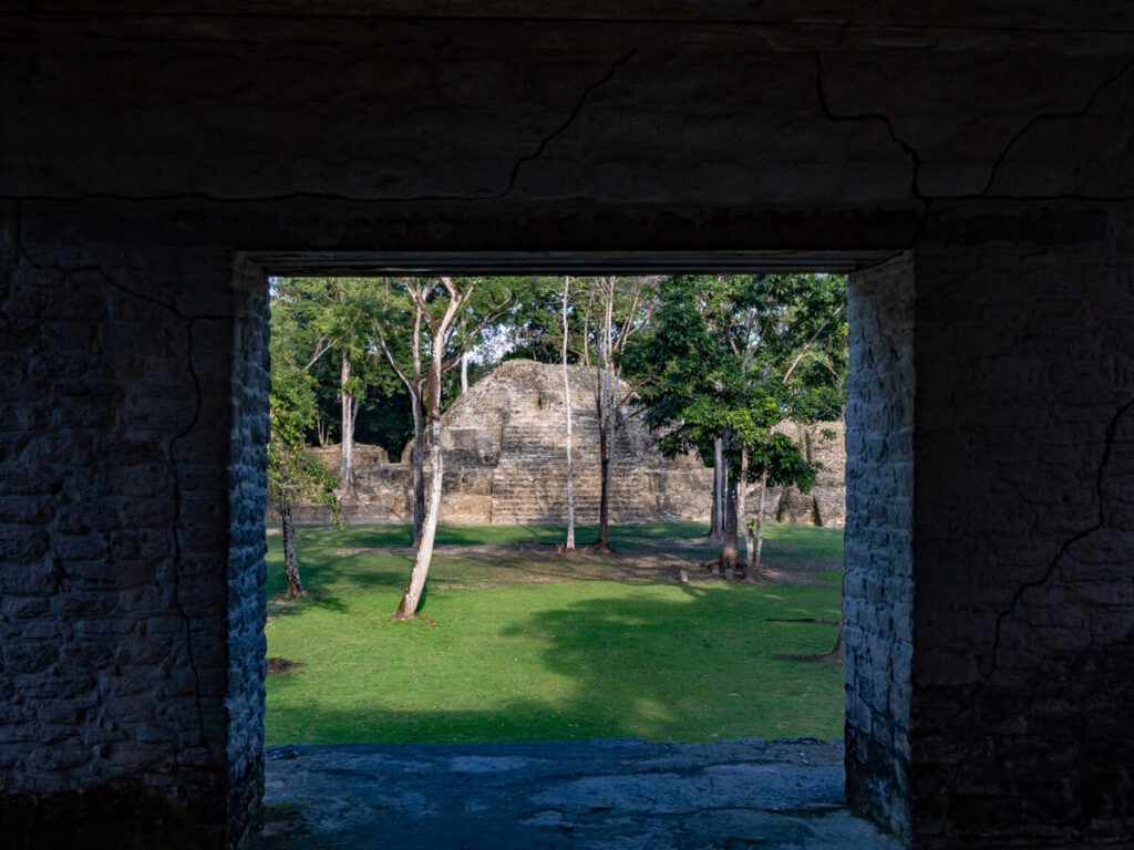 Cahal Pech as viewed through a large doorway. This Mayan archaeological site is quite small and located in the town of San Ignacio, Belize.
