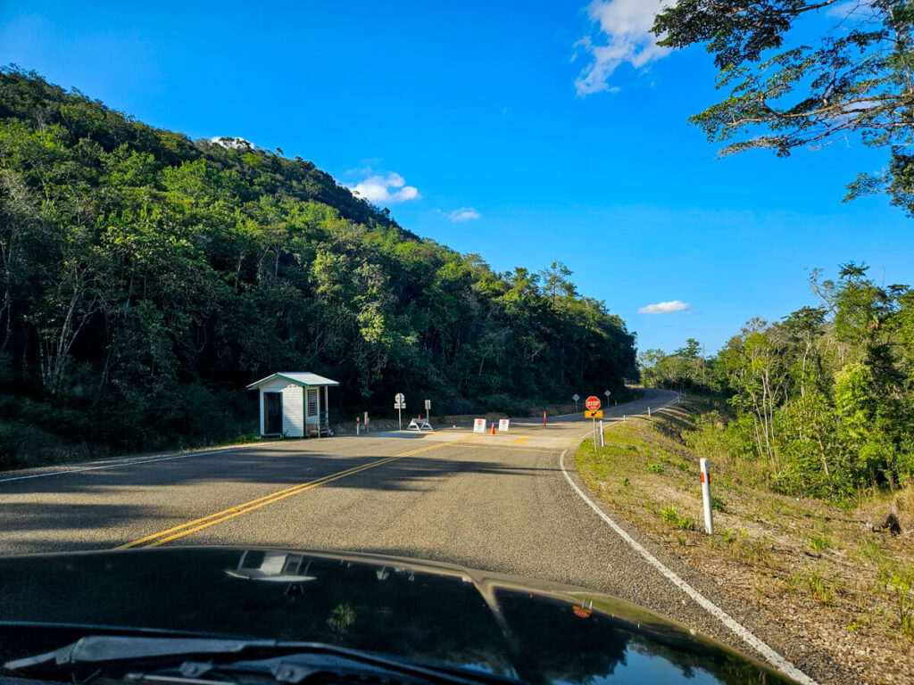 A checkpoint in the road, marking the entrance to Mountain Pine Ridge Forest Reserve.