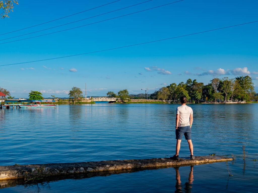 Dan standing on concrete jutting out into Lake Peten Itza in Flores, Guatemala.