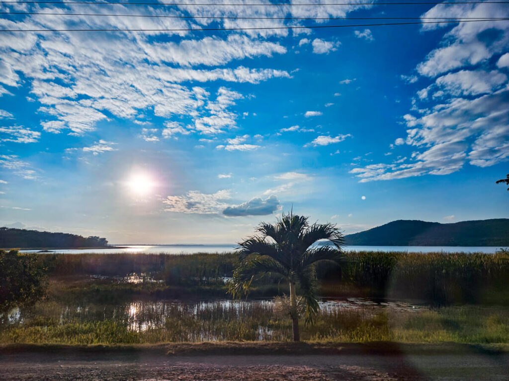 Sun blazing across a lake at El Remate near Flores, Guatemala.