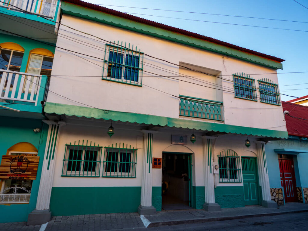 The white and green façade of Hotel Casa Turquesa, one of the best places to stay in Flores, Guatemala.