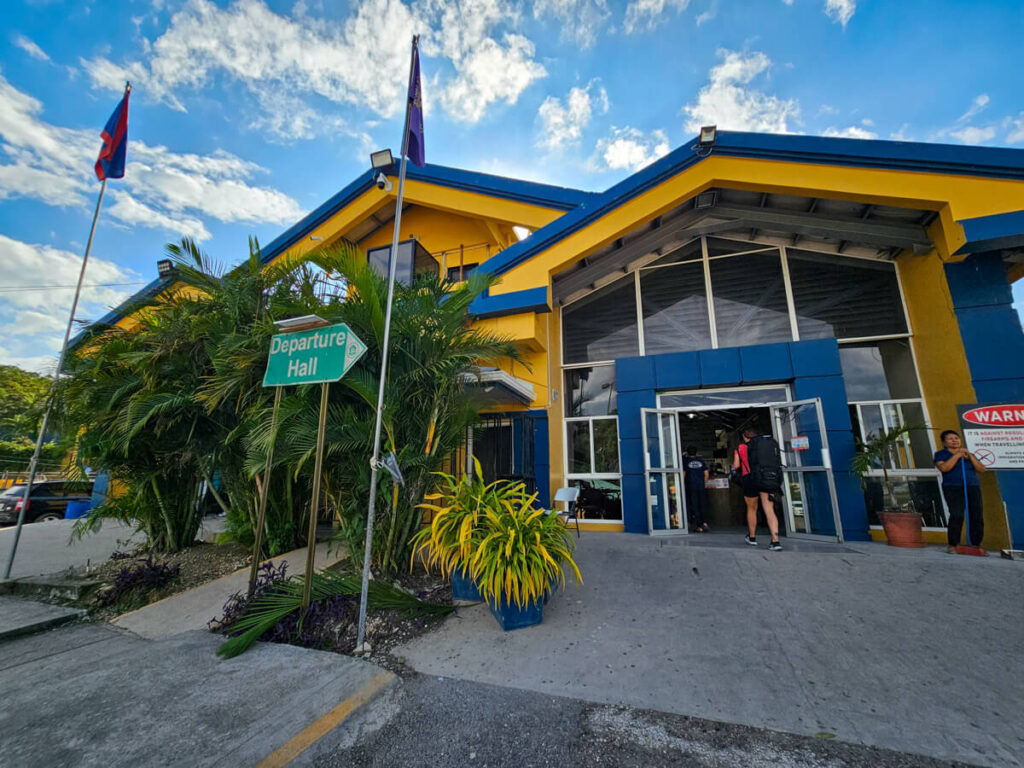 The yellow and blue Departure Hall on the Belize side of the border crossing to Guatemala.