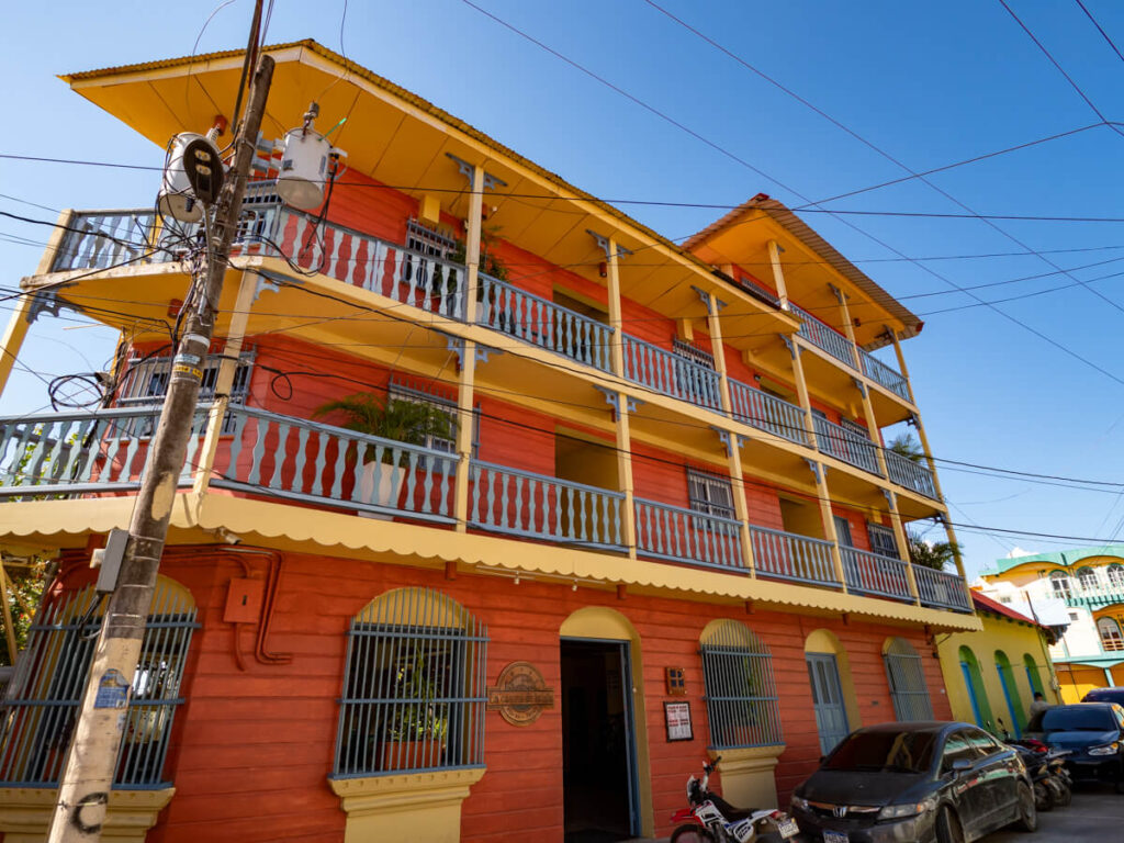 The red and yellow façade of a hotel in Flores, Guatemala.