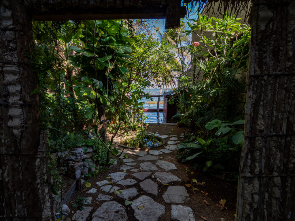 A leafy courtyard overlooking Lake Peten Itza in one of the best restaurants in Flores, Guatemala.