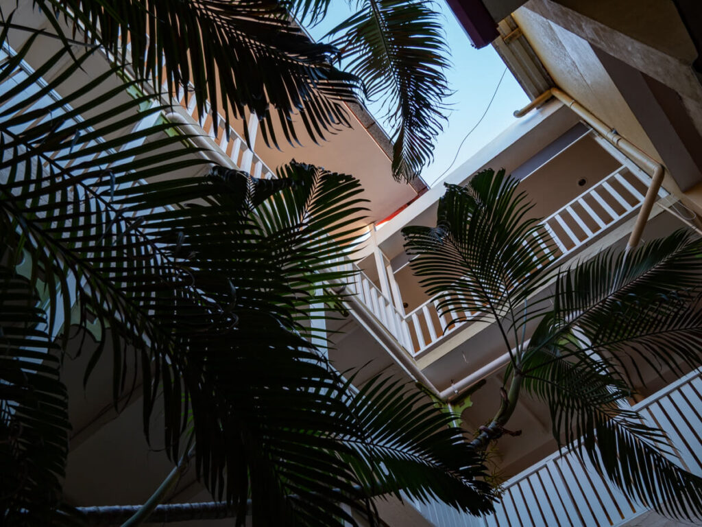 Looking up at terraces covered in plants, inside a hotel in Flores, Guatemala