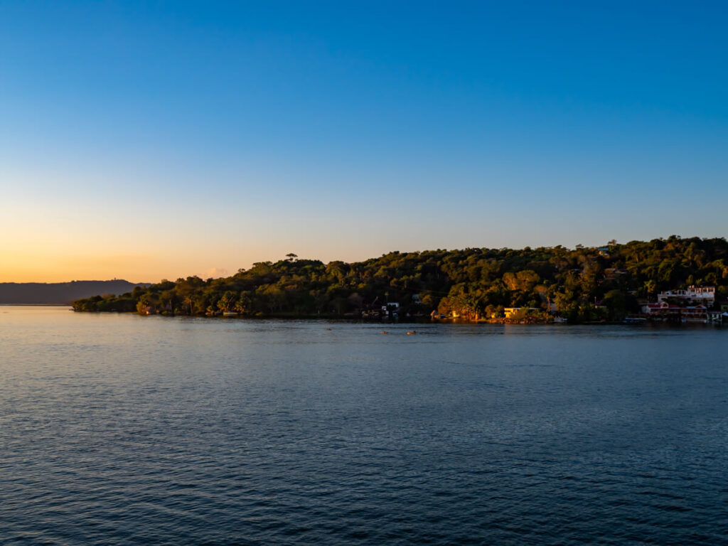 Golden light on the jungle backed town opposite Flores on Lake Peten Itza.