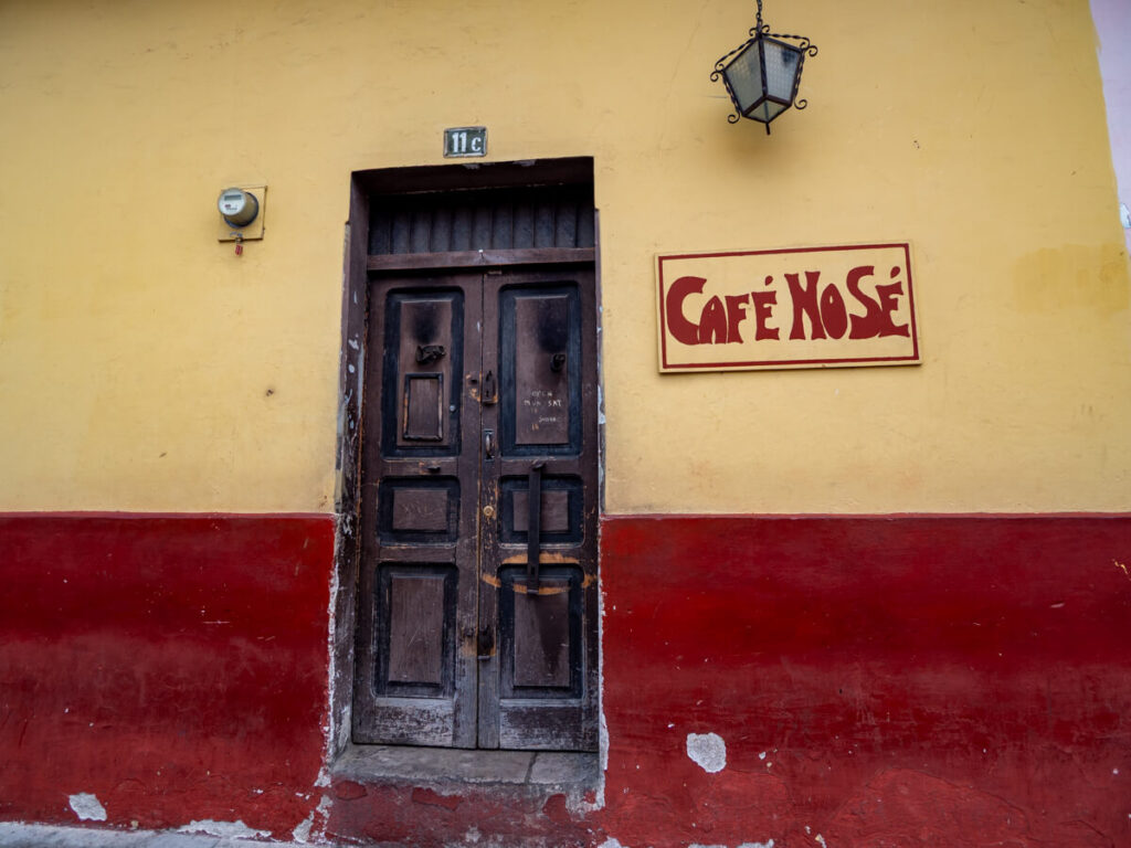 The nondescript, yellow and red façade of Café No Se, one of the coolest bars in Antigua, Guatemala.