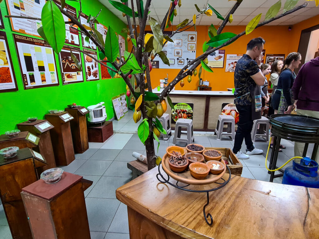 People standing around a demonstration in ChocooMuseo, Antigua's chocolate museum.