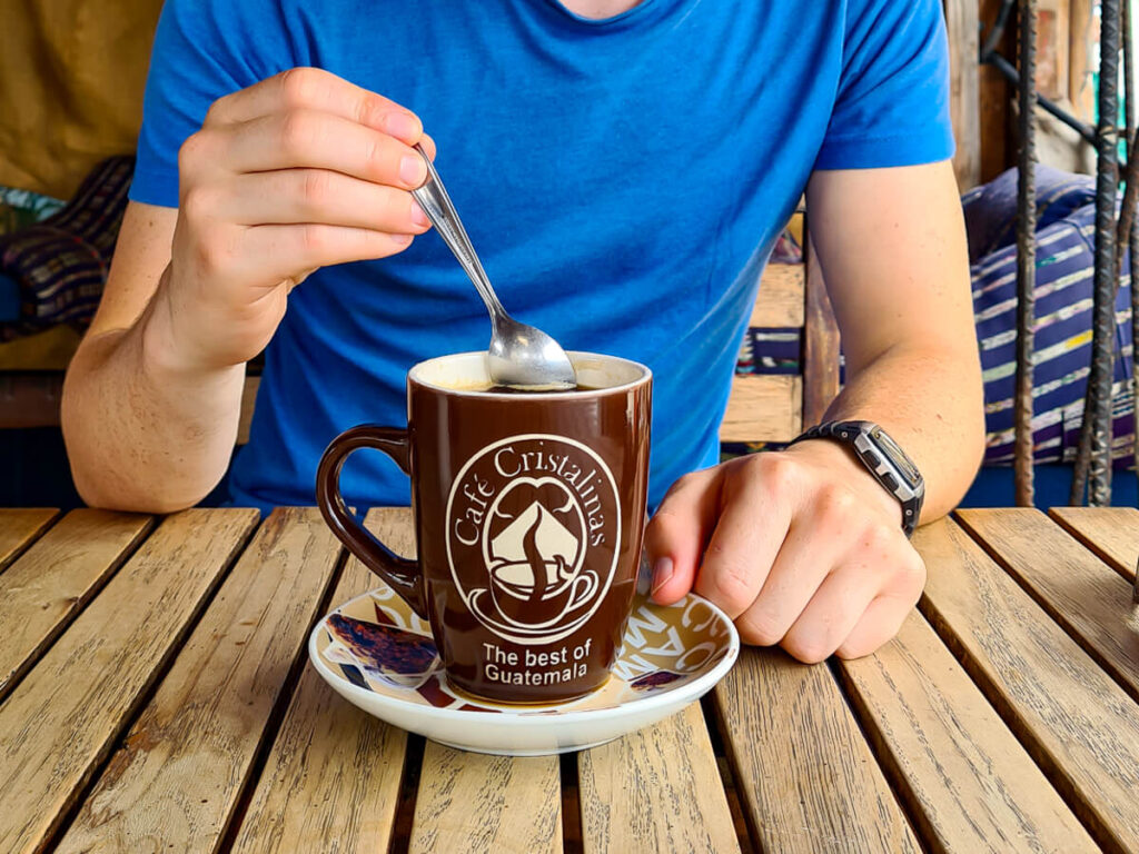 Dan stirring a coffee in a café in San Pedro La Laguna, Lake Atitlán, Guatemala.