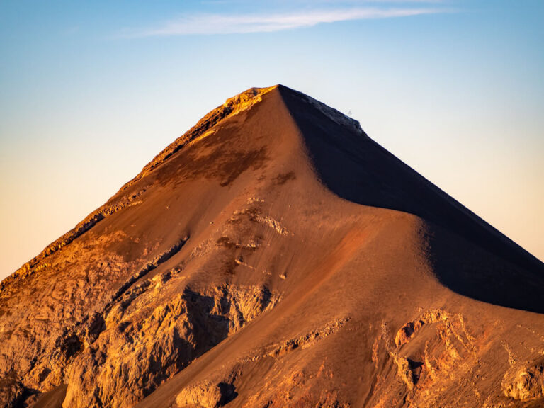A clear view of Fuego Volcano bathed in golden sunlight.