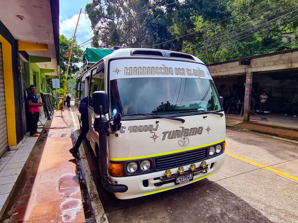 A tourist shuttle bus headed for Antigua, parked by the side of the road in Lake Atitlán.
