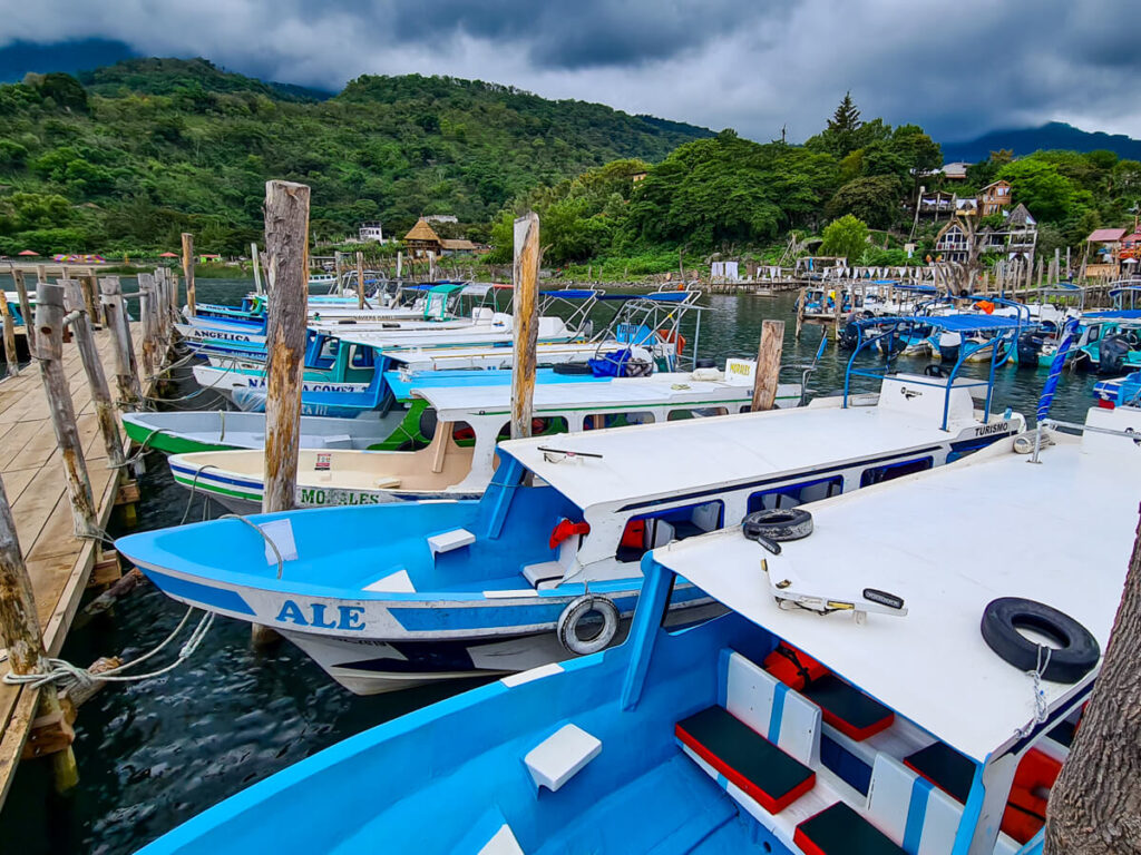 A row of lanchas (boats) moored at a dock on Lake Atitlán, Guatemala.