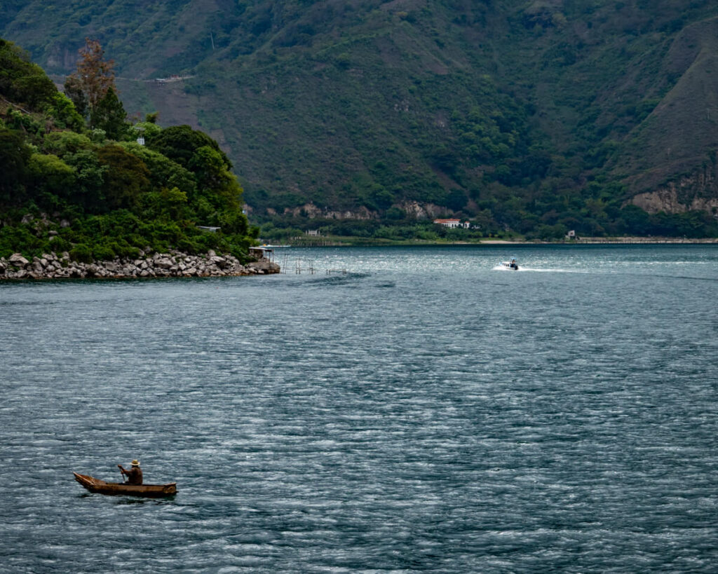 A traditional Maya canoe on Lake Atitlán in front of dramatic mountains in San Pedro La Laguna, Lake Atitlán, Guatemala.