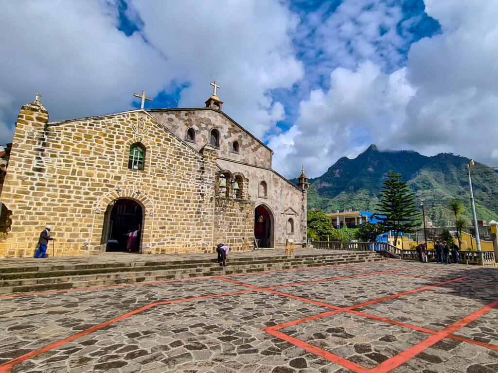 A charming church in a plaza with mountain views in San Juan La Laguna, Lake Atitlán.