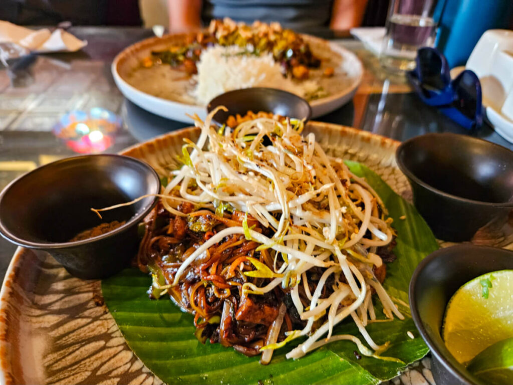 Asian food on plates in Samsara Vegetarian Restaurant, one of the best places to eat in Antigua, Guatemala.