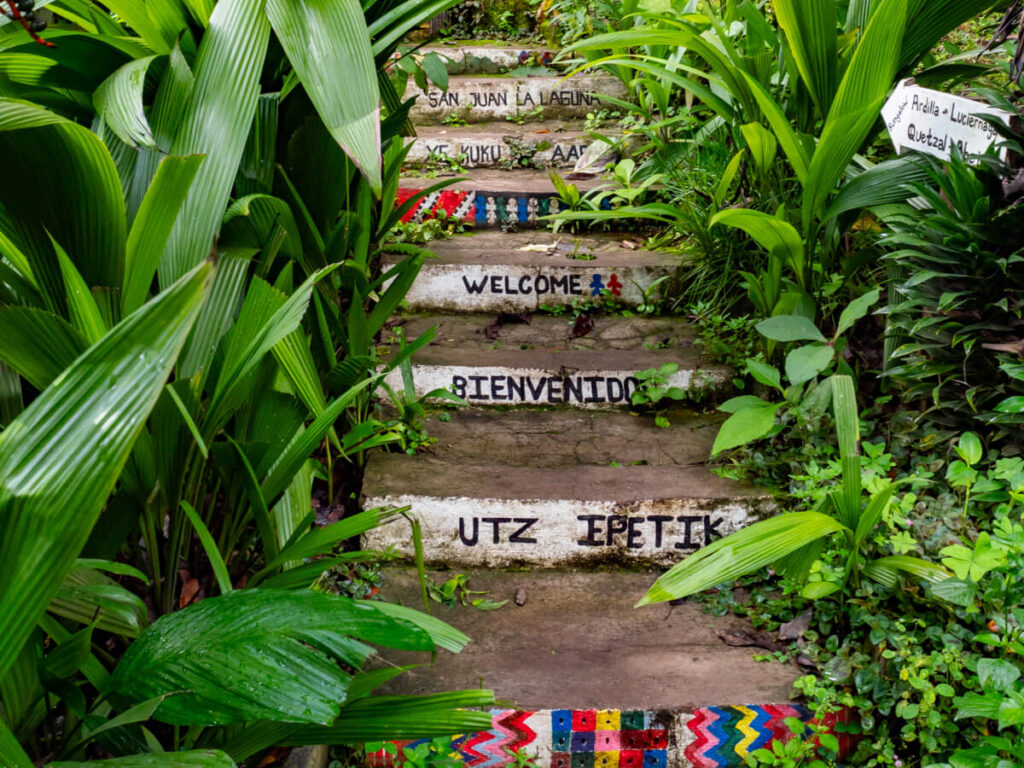 Painted stairs leading through green foliage in Lake Atitlán, Guatemala.