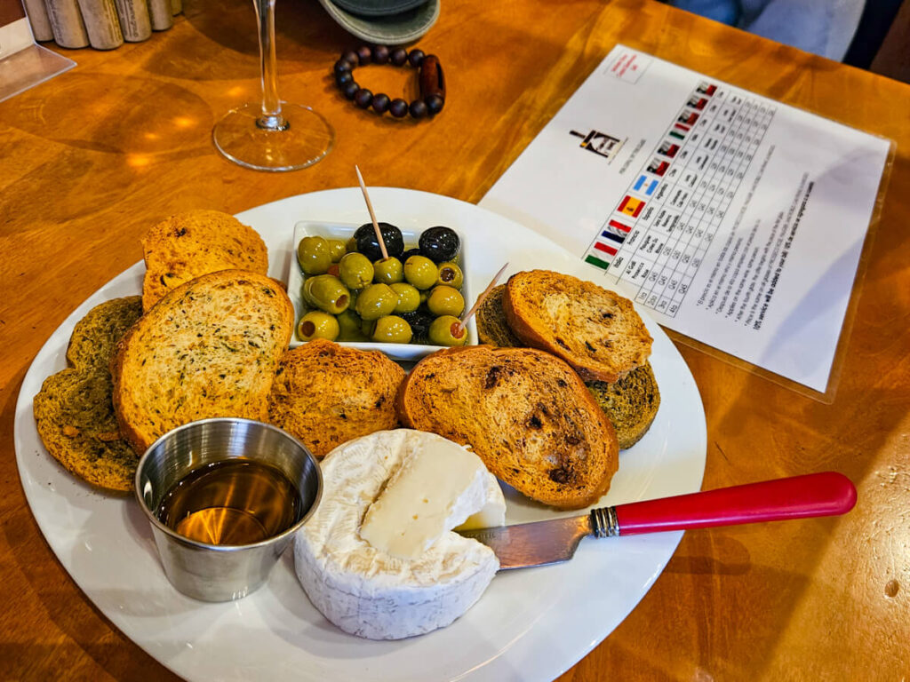 A plate of cheese and olives accompanying wine in Tabacos y Vinos, one of the best bars in Antigua, Guatemala.