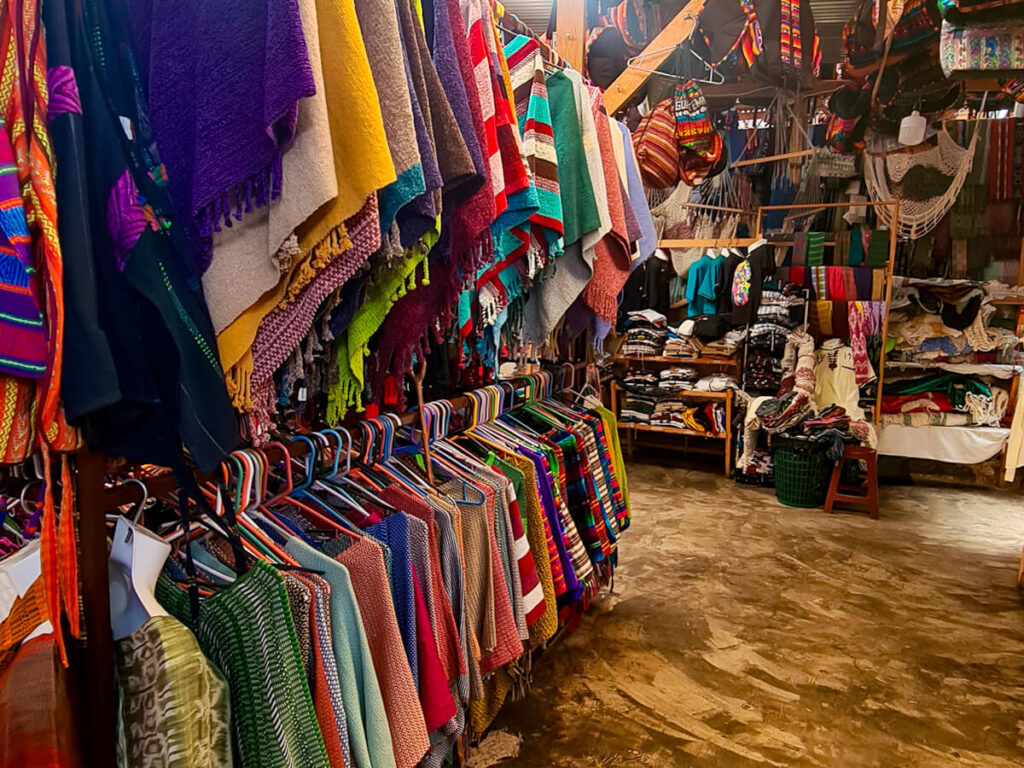 A row of colourful ponchos in a weaving cooperative in Lake Atitlán, Guatemala.