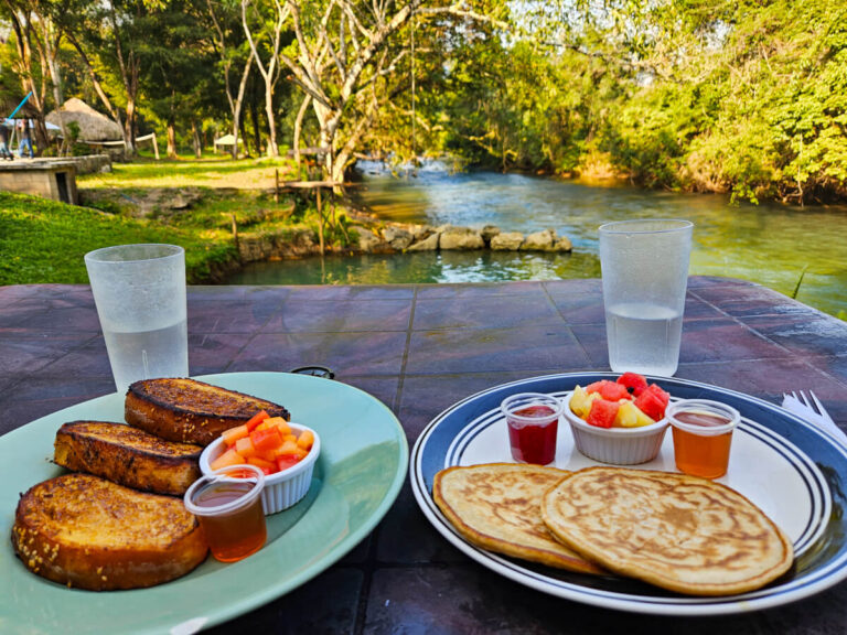 Plates of pancakes and French toast on a table in a riverside hotel in Lanquín near Semuc Champey.