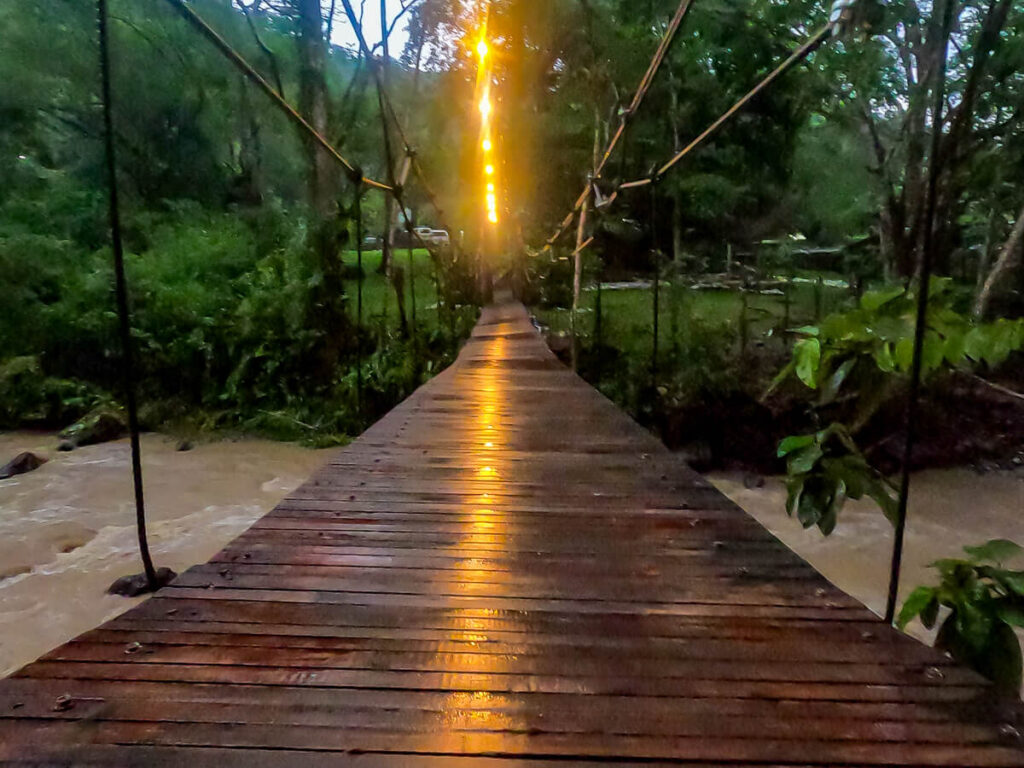 A wooden bridge crossing a river in Luna Jaguar Spa, near Copán Ruinas, Honduras.
