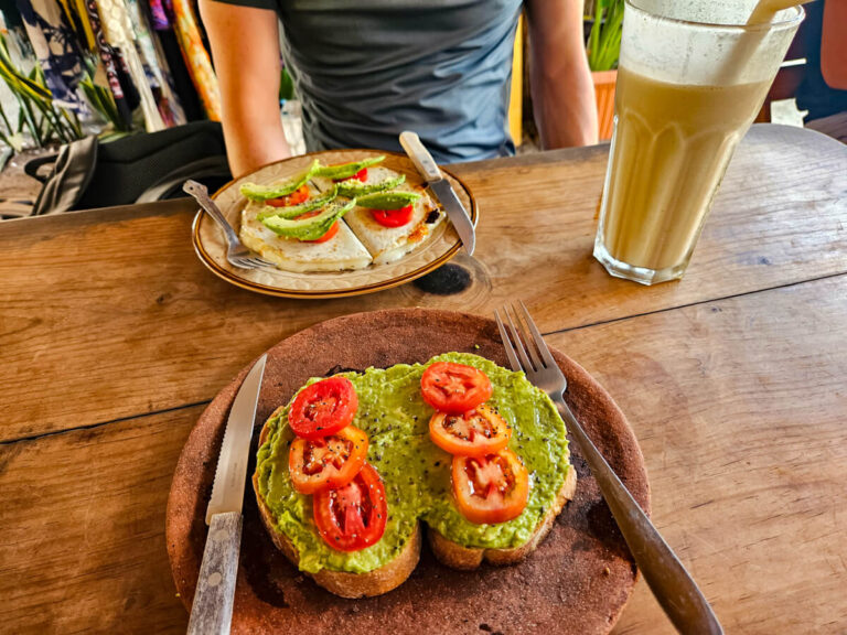 Plates of avocado toast and quesadillas in Cafecito Del Mar, one of the best cafes in El Paredón, Guatemala.