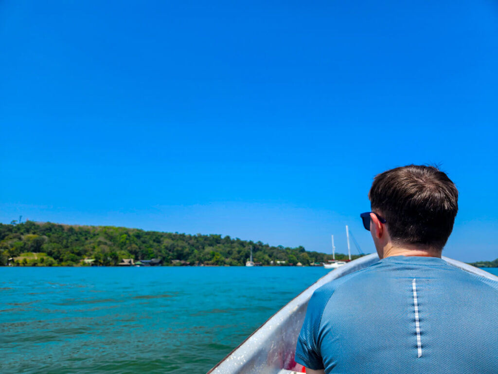 Dan in a lancha (boat) on the way to a riverside lodge in Río Dulce, Guatemala.
