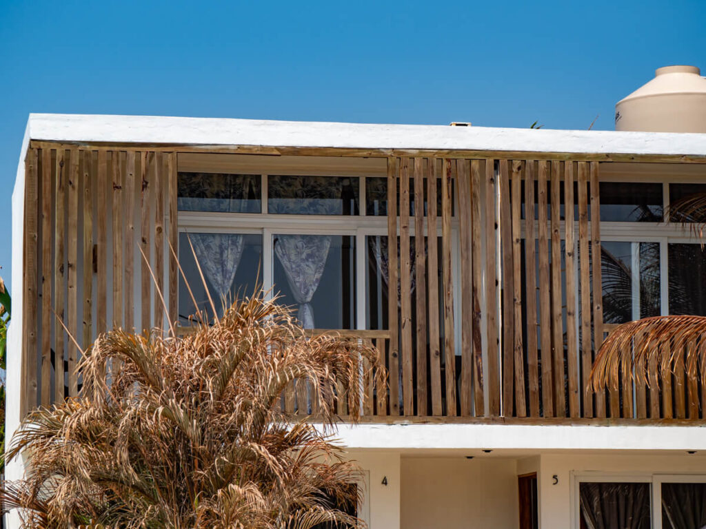 Hotel rooms with curtains and wooden features looking out over El Paredón.