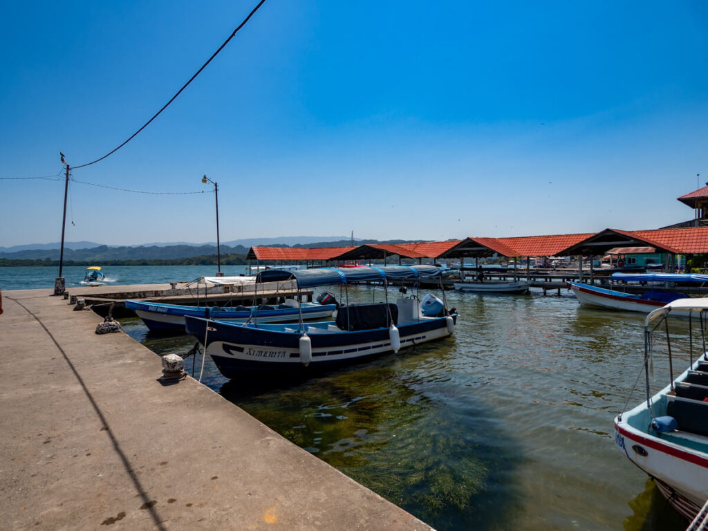 Lanchas (boats) moored at the main dock in Livingston, Guatemala.