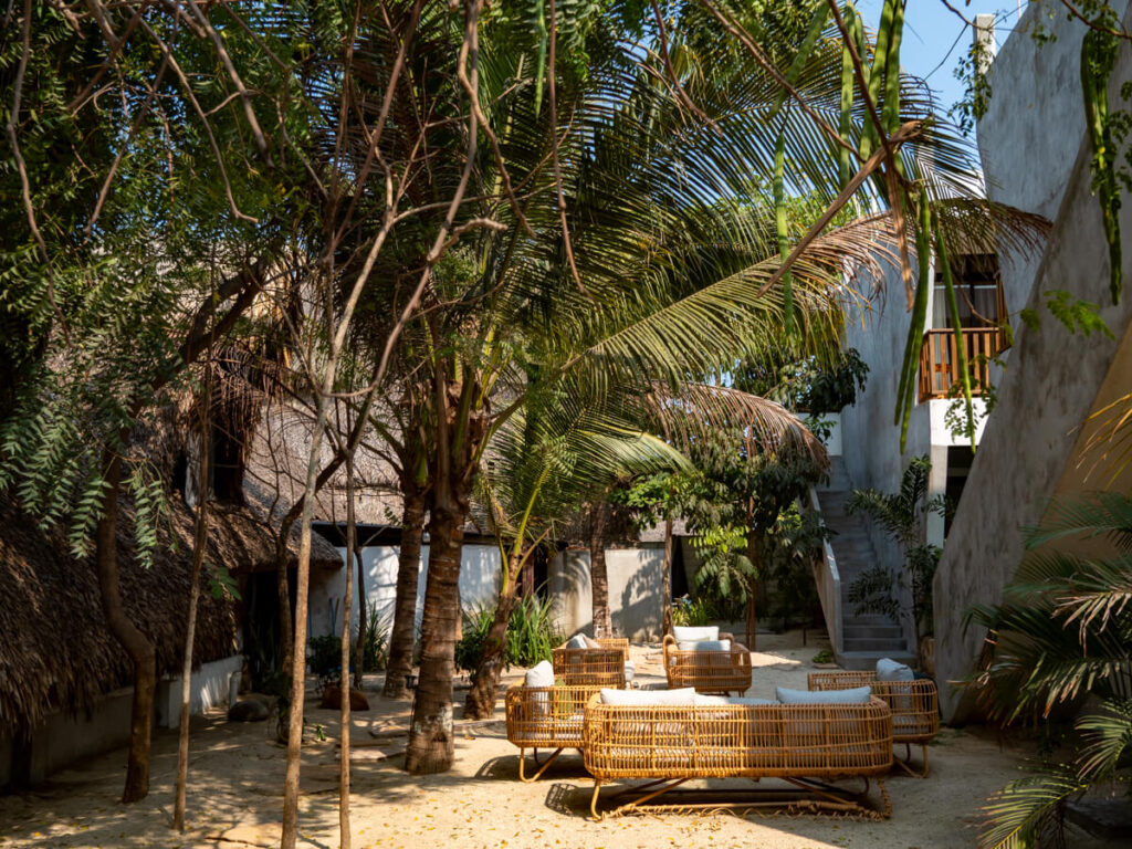 Wicker furniture in a courtyard in Hotel Pacifico in El Paredón.