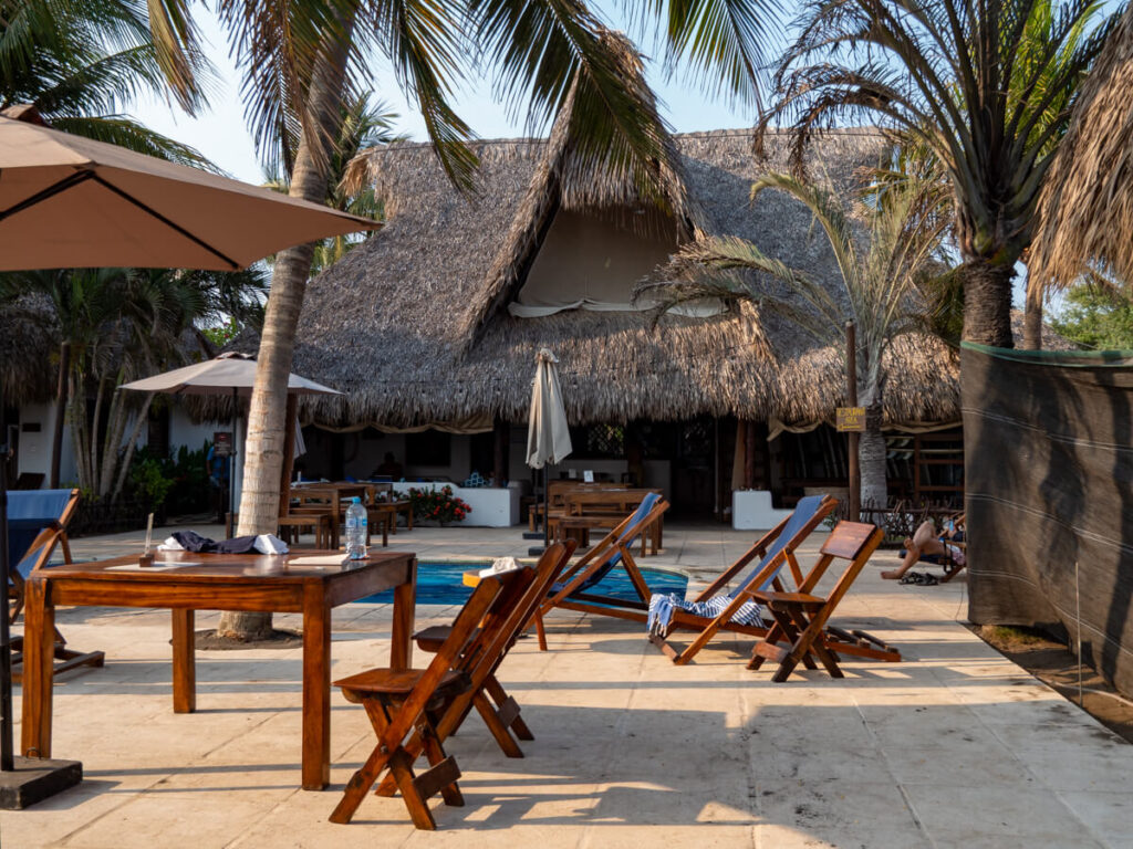Wooden sun loungers around the pool in Paredon Surf House, a popular place to stay in El Paredón.