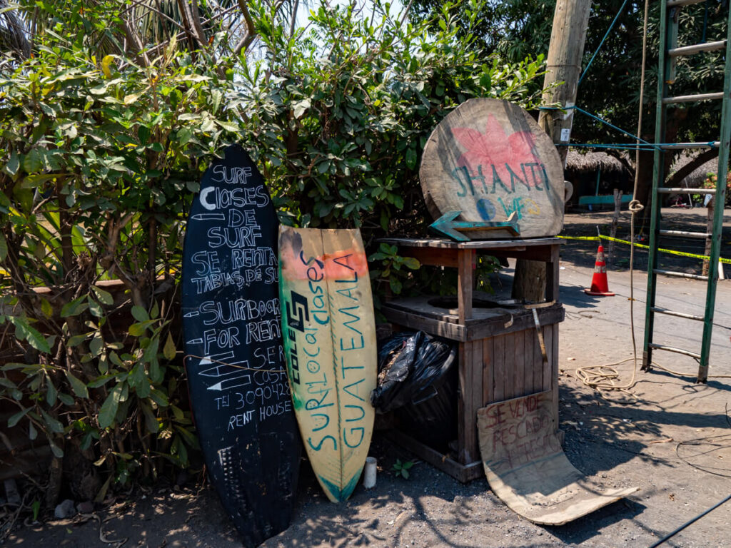 Surfboards with writing advertising Shanti Surf Camp in El Paredón.
