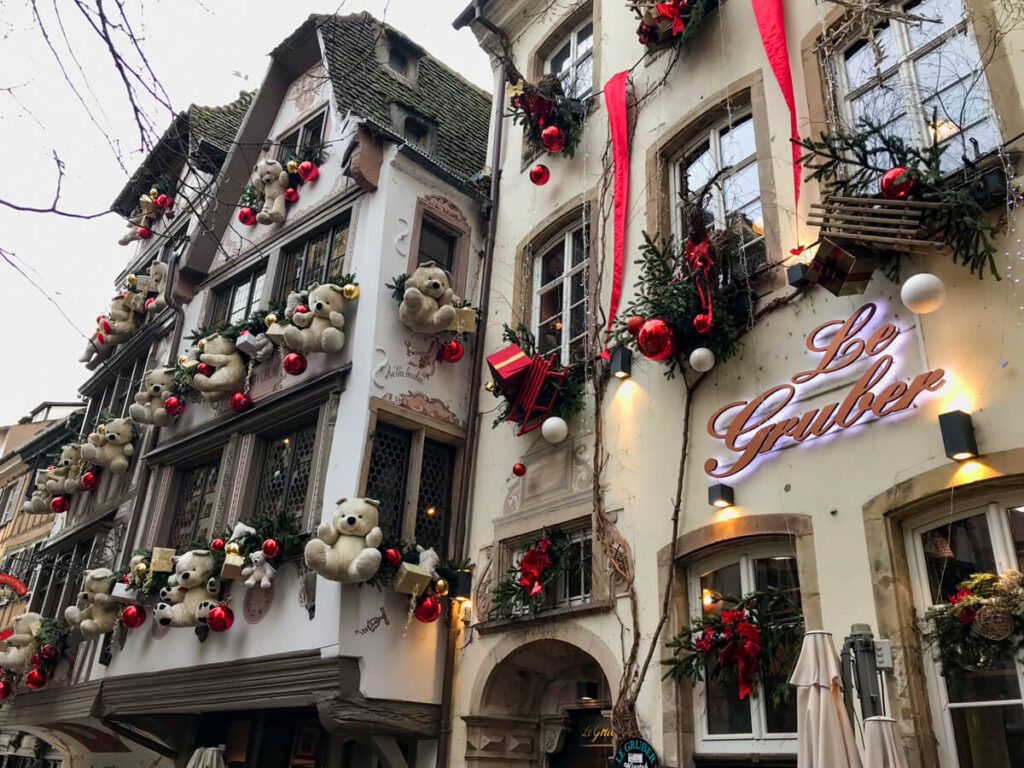 A building decorated with teddy bears and tinsel in Strasbourg.