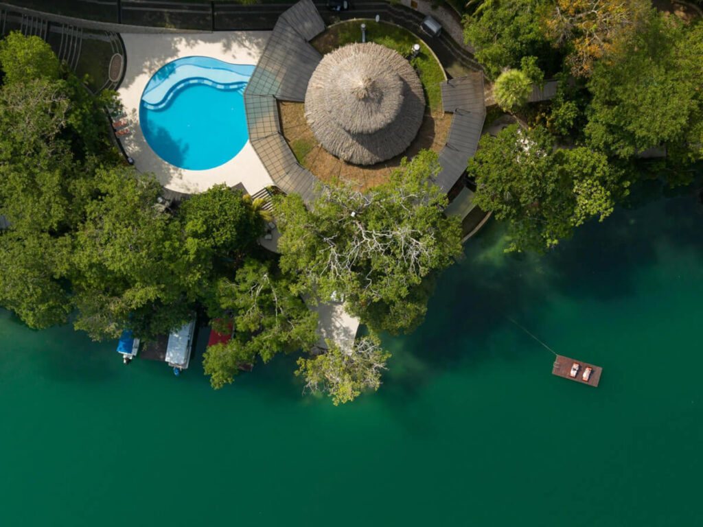 An aerial view of the luxurious Bolontiku Boutique Hotel and Spa on the water near Flores, Guatemala.
