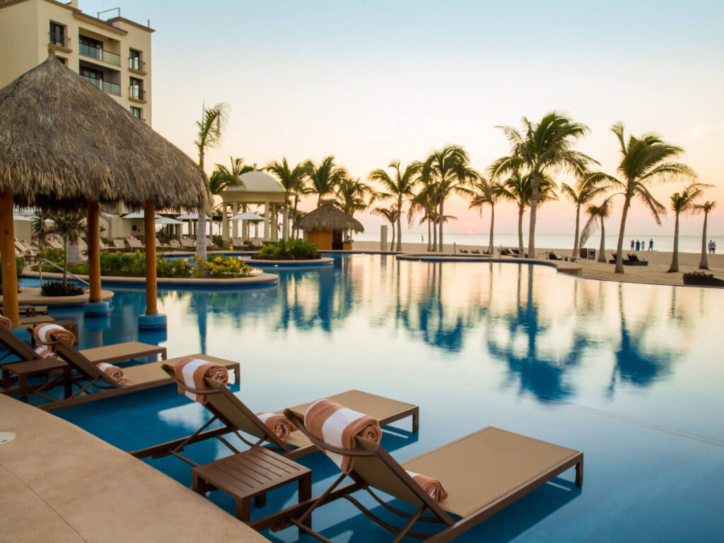Loungers by a pool overlooking the sea at the Hyatt Ziva Los Cabos.