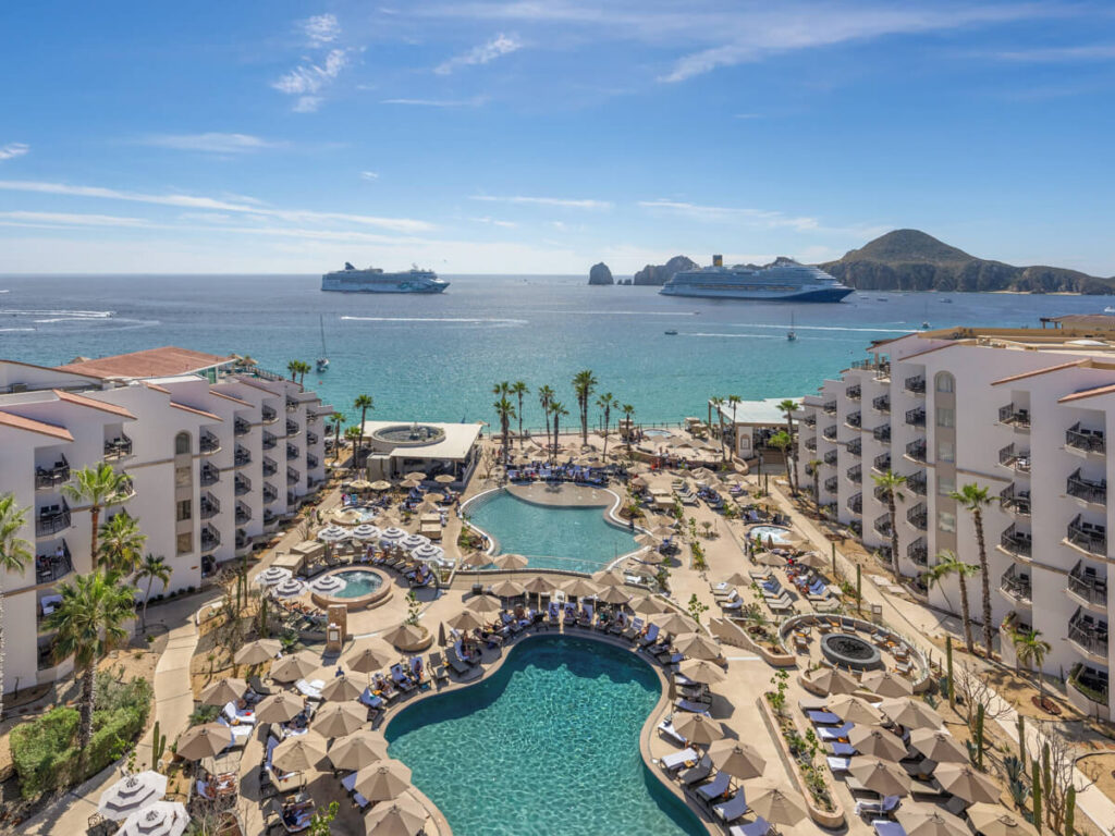 The sprawling complex of the Villa Del Palmar Beach Resort & Spa in Cabo San Lucas, with rooms overlooking a large pool and the sea.