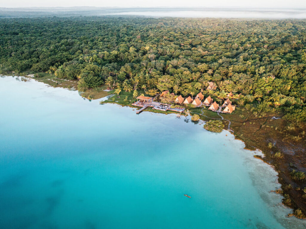 A luxury hotel on the blue lagoon, surrounded by greenery, at Our Habitas Bacalar.