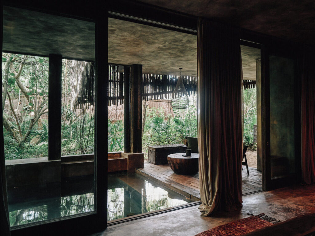 A wooden deck with a plunge pool overlooking the lush jungle in Nomade, one of the best hotels in Tulum.