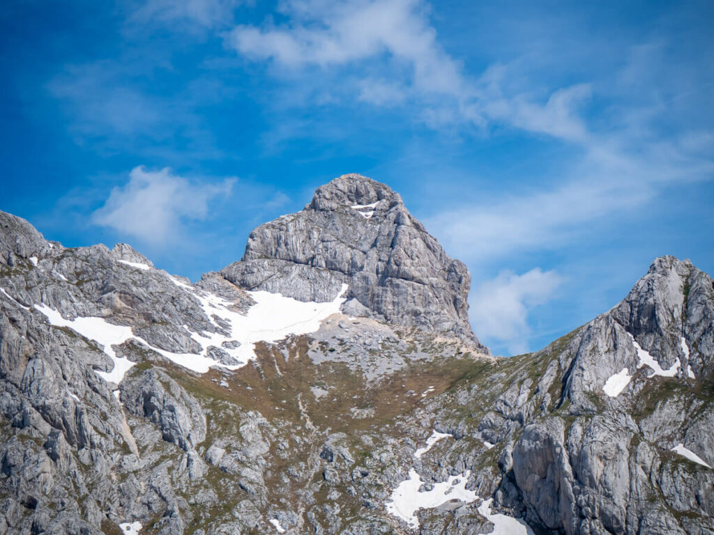The cube-shaped peak of Bobotov Kuk against a blue sky.